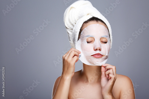 Model pulling away mask from face
