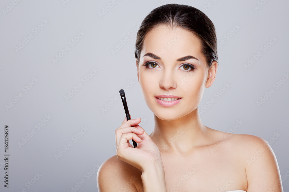 Fototapeta premium Girl holding with brush near face