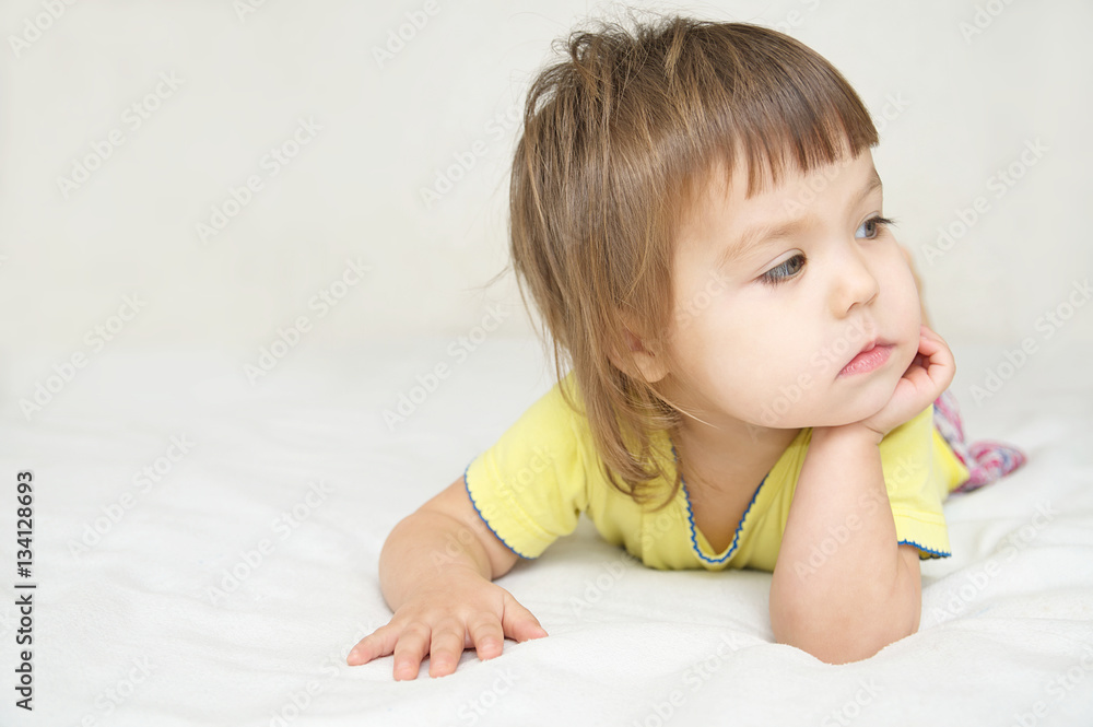 thoughtful child , thinking Little girl lying on bed looking away, meditative and pensive kid thoughtful child , thinking Little girl lying on bed looking away, meditative and pensive kid