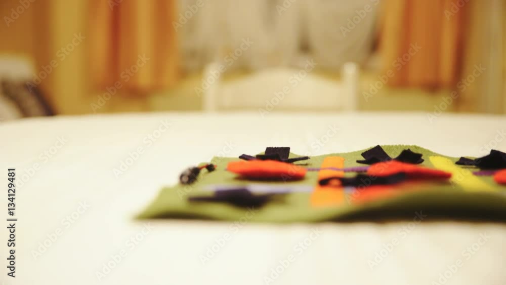 Dolly slide unfolding textile game on table closeup 4K
Dolly slide unfolding textile game on table closeup 4K