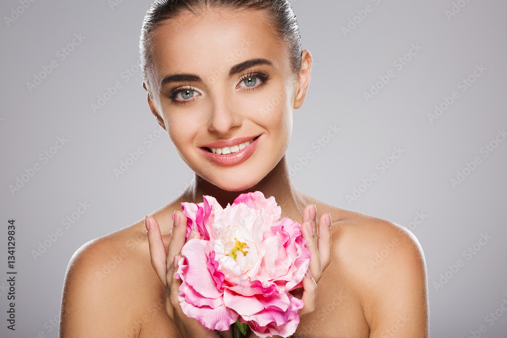 Beauty portrait of model with big pink flower Beauty portrait of model with big pink flower