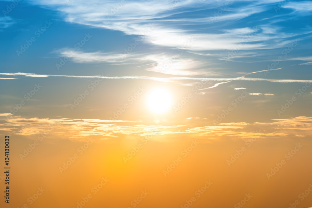 Fototapeta premium Sunset in the sky with blue orange clouds