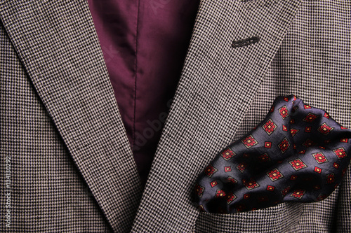 silk pocket square - handkerchief in the breast pocket of a man's wool luxury suit. vintage style.