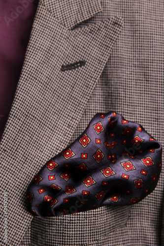 silk pocket square - handkerchief in the breast pocket of a man's wool luxury suit. vintage style.