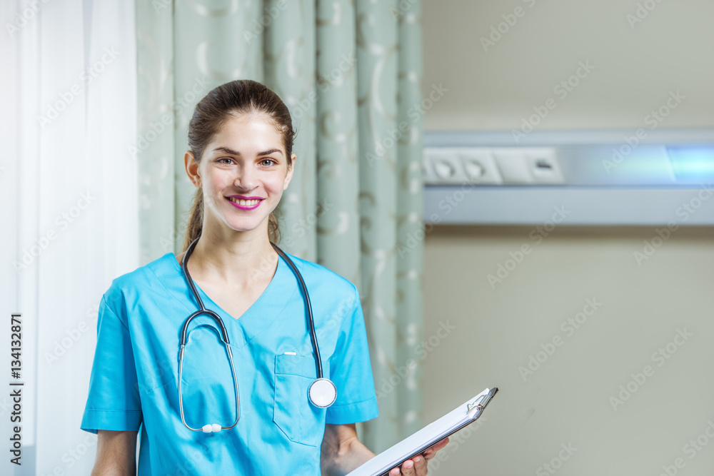 woman doctor or nurse standing in hospital room
