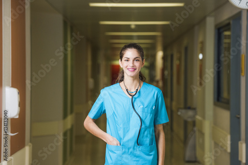 woman doctor or nurse is standing in a hospital corridor