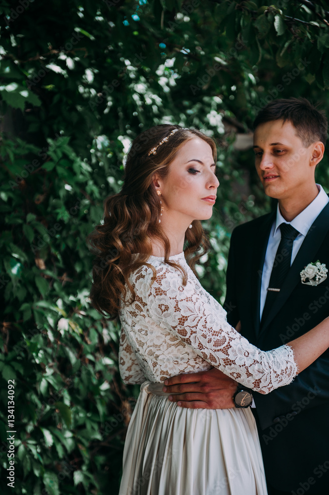 happy bride and groom at a park on their wedding day happy bride and groom at a park on their wedding day