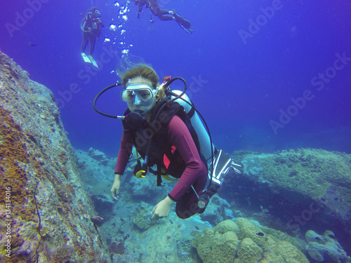 Underwater scuba diving selfie shot with selfie stick. Deep blue sea. Wide angle shot. © tirachard