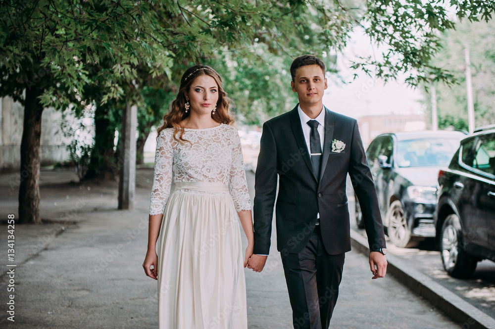 happy bride and groom at a park on their wedding day happy bride and groom at a park on their wedding day
