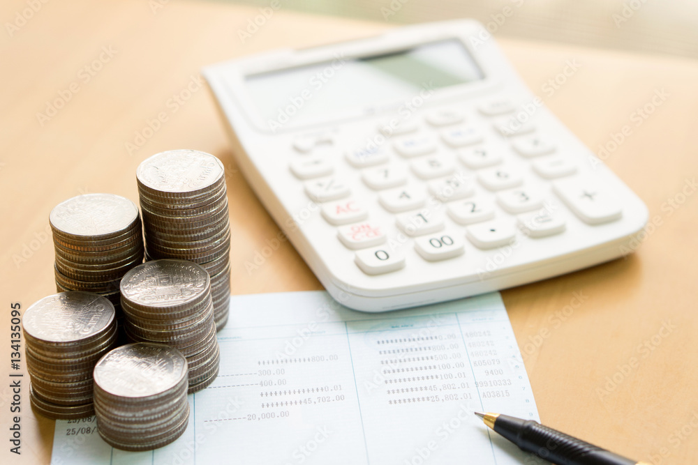 Coins stack in columns with saving book finance and banking conc Coins stack in columns with saving book finance and banking conc