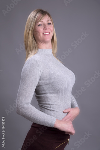 Portrait Of A Busty Middle Aged Attractive Woman Wearing A Grey Top Stock Photo Adobe Stock