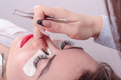 Business woman or girl enjoys salon and upgraded eyelashes  she