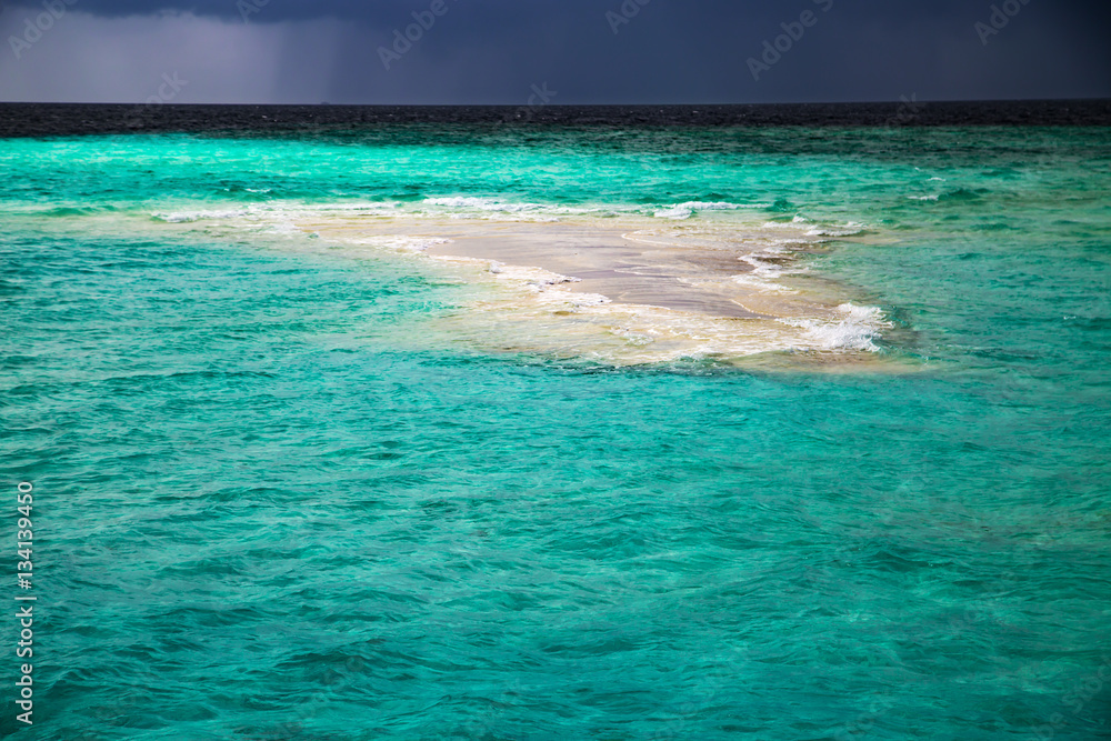 Empty little sand island in ocean, nature landscape Empty little sand island in ocean, nature landscape