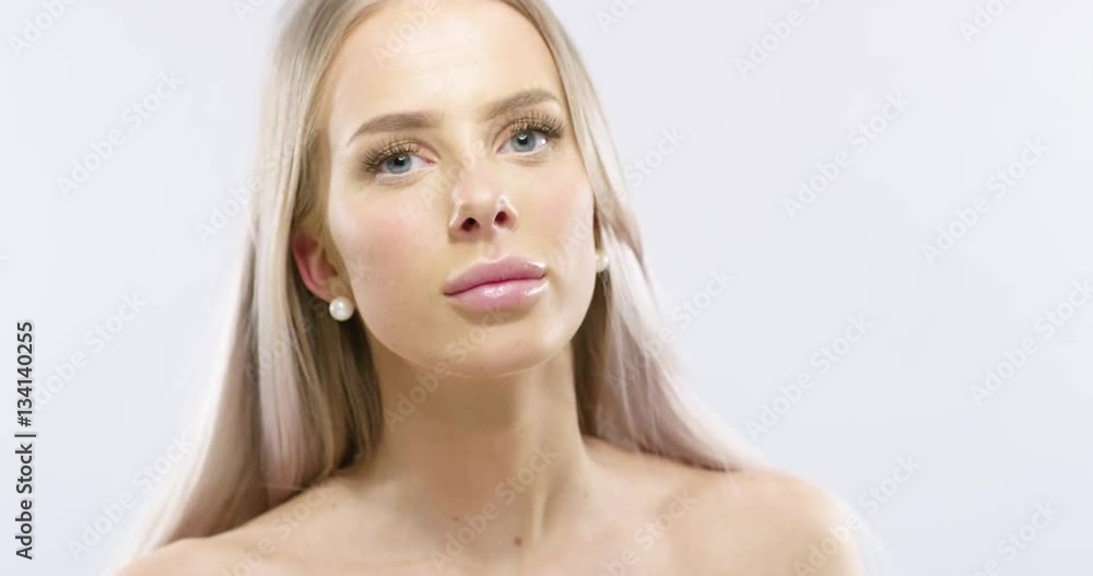 Studio portrait of a smiling young woman with long blonde hair Studio portrait of a smiling young woman with long blonde hair