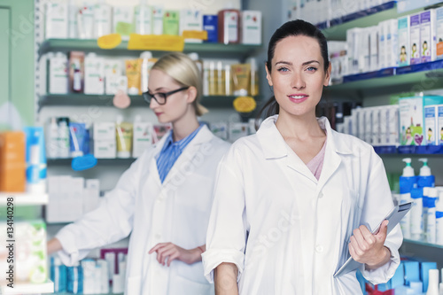 young woman pharmacist is holding a tablet pc