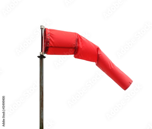 Windsock poiting the position of the wind. Red windsock isolated on white background, also known as Biruta de Vento in portuguese. photo