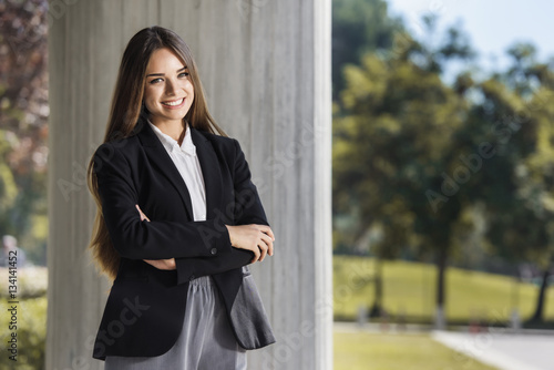 Beautiful young businesswoman portrait with crossed arms