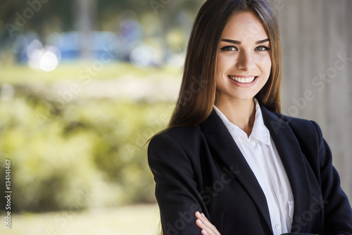 Beautiful young business woman, smiling, close up portrait. With copy space. photo