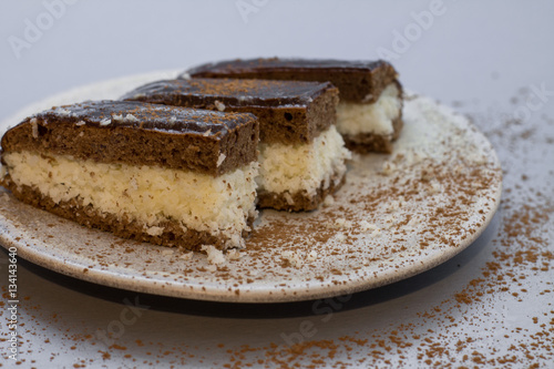 Chocolate cake "Bounty"  with coconut on plate. 
