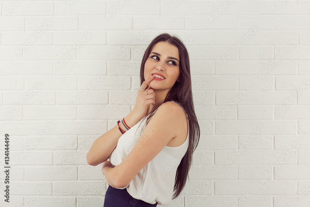 Business woman daydreaming thinking smiling white bricks wall background. Positive human emotions Business woman daydreaming thinking smiling white bricks wall background. Positive human emotions