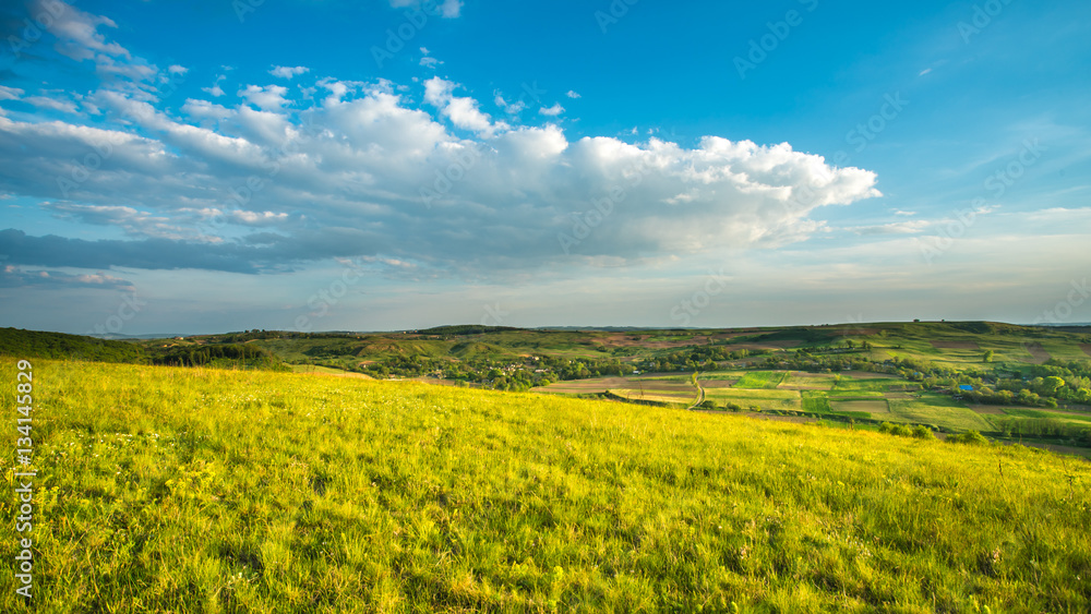 Fototapeta premium The picturesque field on the background of cloud. Wide angle