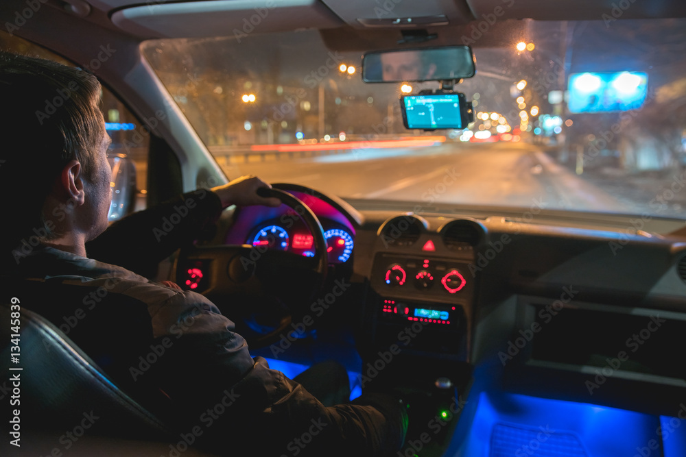 The man drive a car in the night city. Inside view Stock Photo | Adobe ...