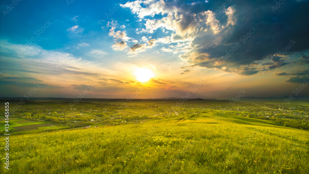 Fototapeta premium The picturesque field on the background of sunrise. Wide angle