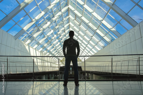 The man stand on the bridge in the business center