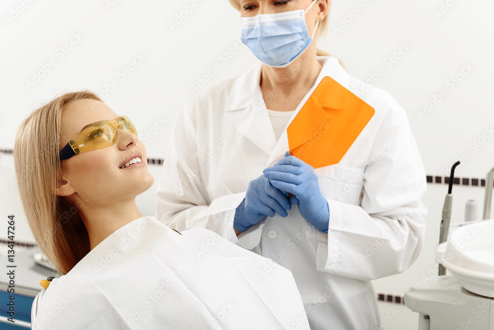 Stomatologist finishing exploration of female mouth Stomatologist finishing exploration of female mouth