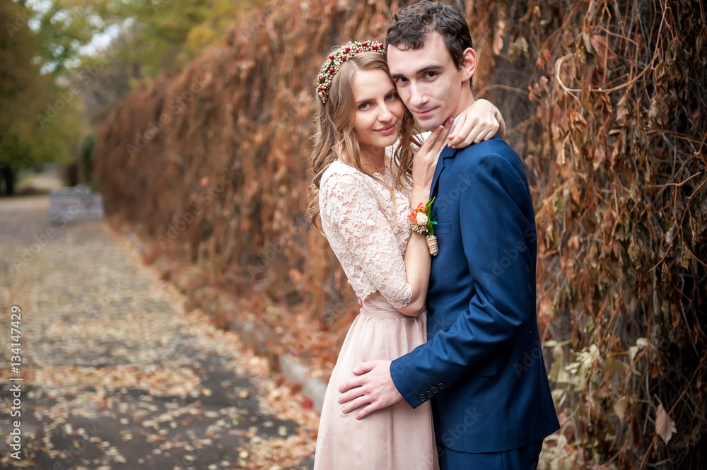 Portrait of happy newlyweds in autumn nature. Happy bride and gr Portrait of happy newlyweds in autumn nature. Happy bride and gr