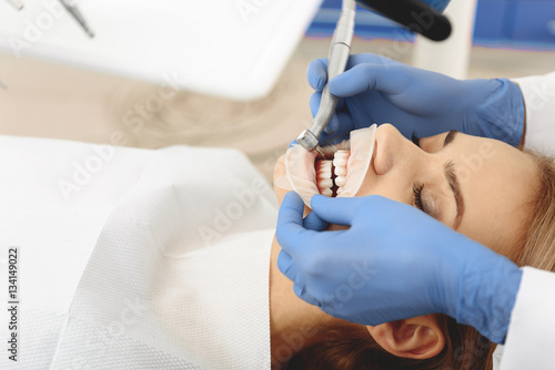 Female having teeth treatment at stomatological clinic