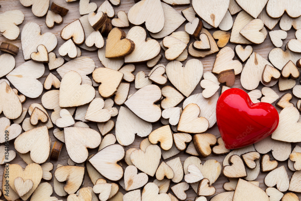 Obraz premium Wooden hearts, one red heart on the heart background.