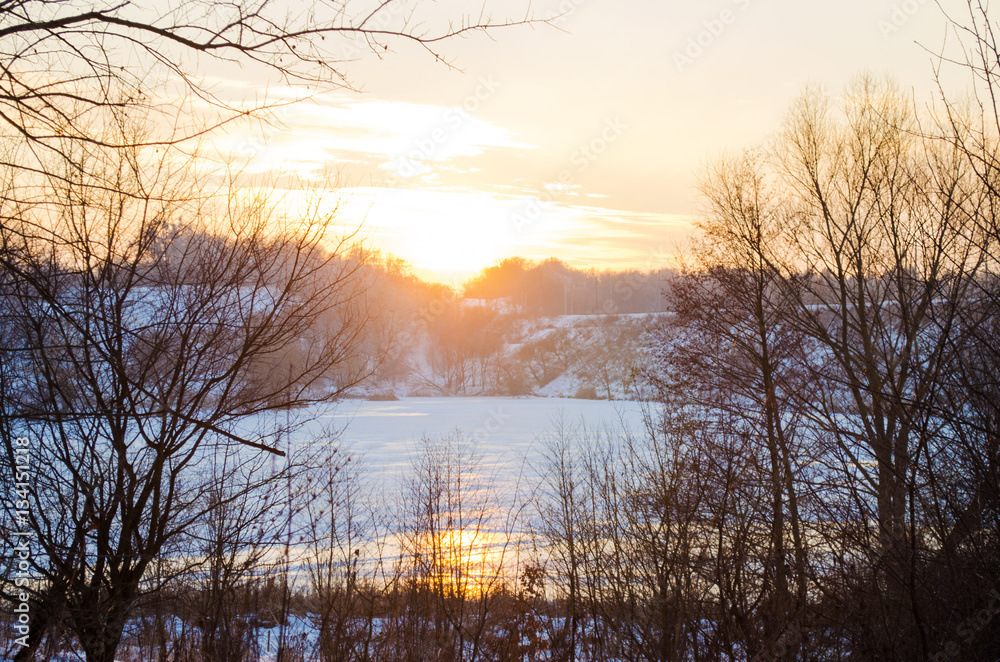 winter forest and the river at sunset winter forest and the river at sunset