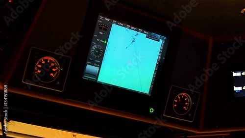 Instrument panel of ship in twilight, in lamplight. Close-up.