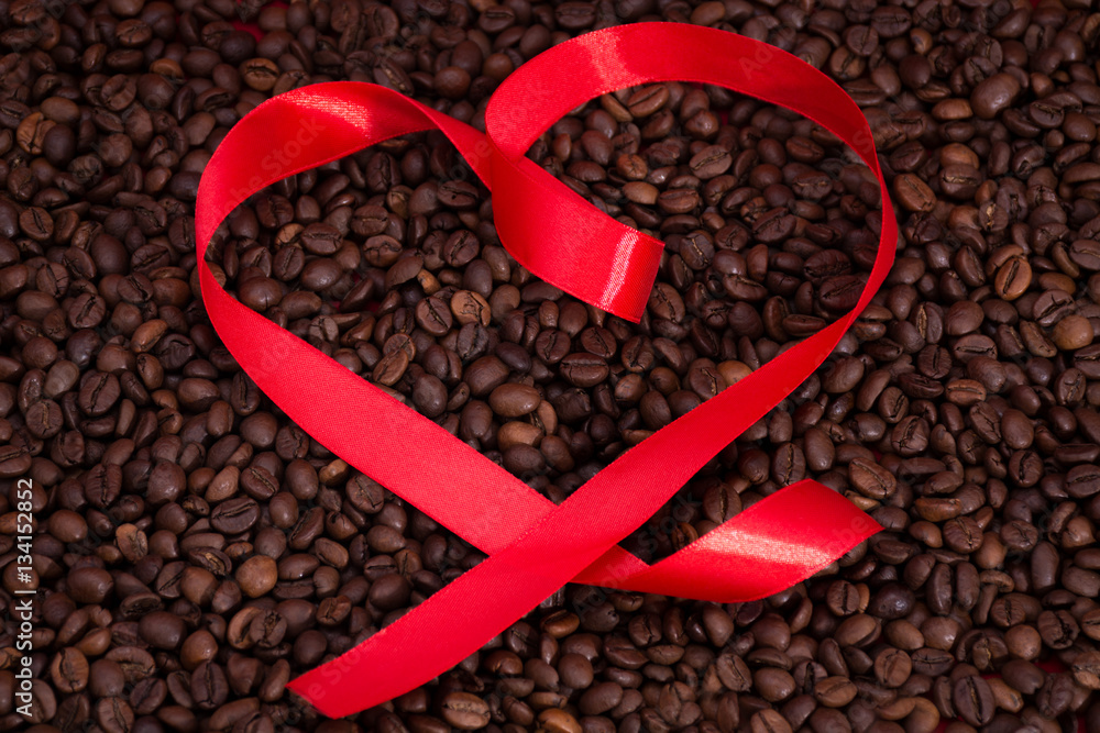 Ribbon heart shape on the coffee background Ribbon heart shape on the coffee background