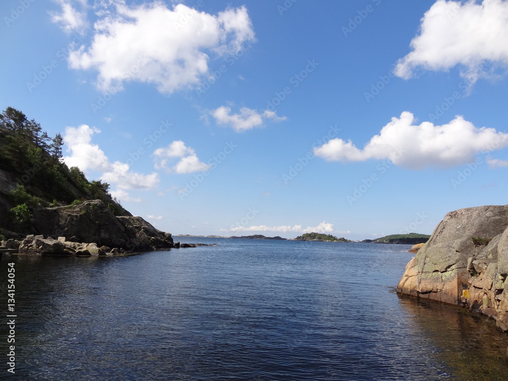Bay with blue sky and clouds near Mandal and Sjosanden beach in Norway