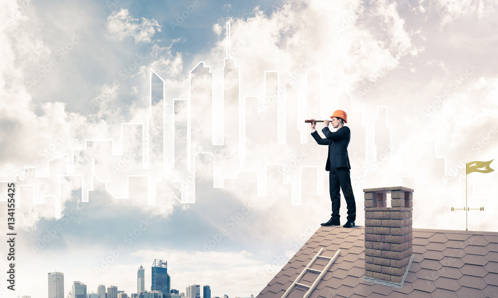 Engineer man standing on roof and looking in spyglass. Mixed med Engineer man standing on roof and looking in spyglass. Mixed med