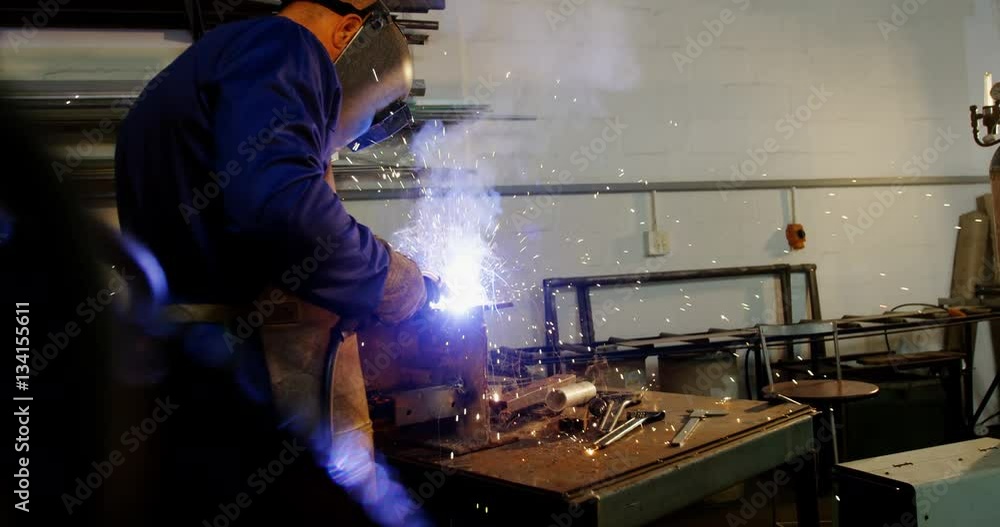Welder welding a metal Welder welding a metal