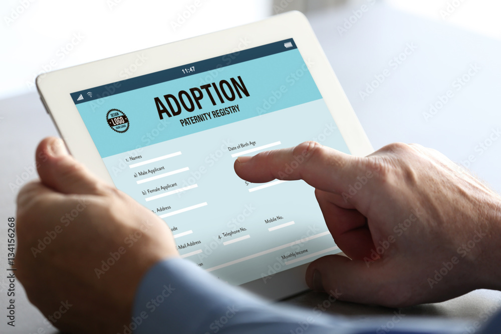 Adoption concept. Man filling in paternity form on tablet Adoption concept. Man filling in paternity form on tablet