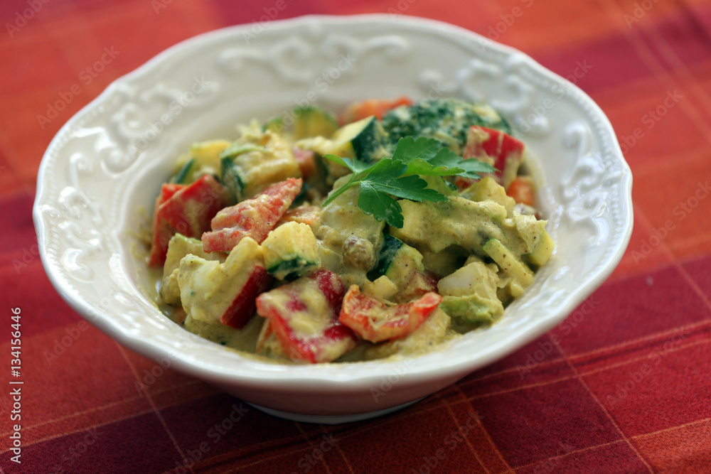 Homemade salad with spicy dressing on table