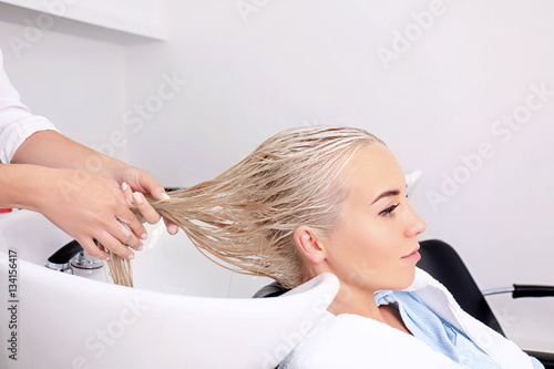 Hairdresser washing woman's...