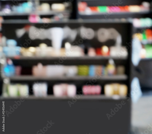 Blurred background of cosmetics on shelves in supermarket
