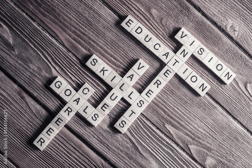 Fototapeta premium Conceptual keywords on wooden table with elements of game making crossword