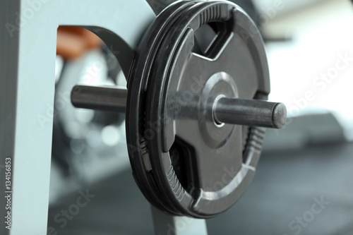 Rack with weight plates in gym, close up view