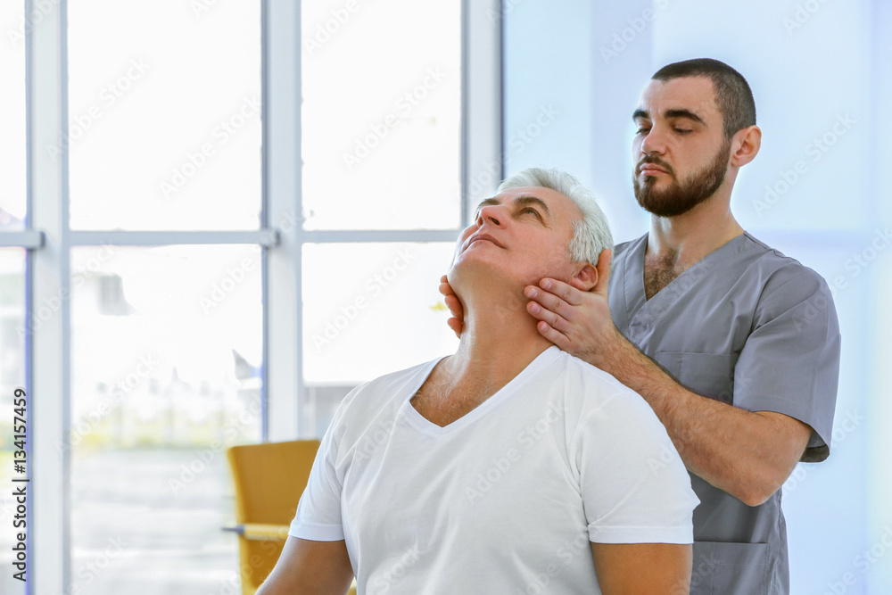 Physiotherapist working with patient in clinic Physiotherapist working with patient in clinic