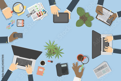 Business desk top view with hands, laptop, documents and tablet. Concept of team work, brainstorming and conference.