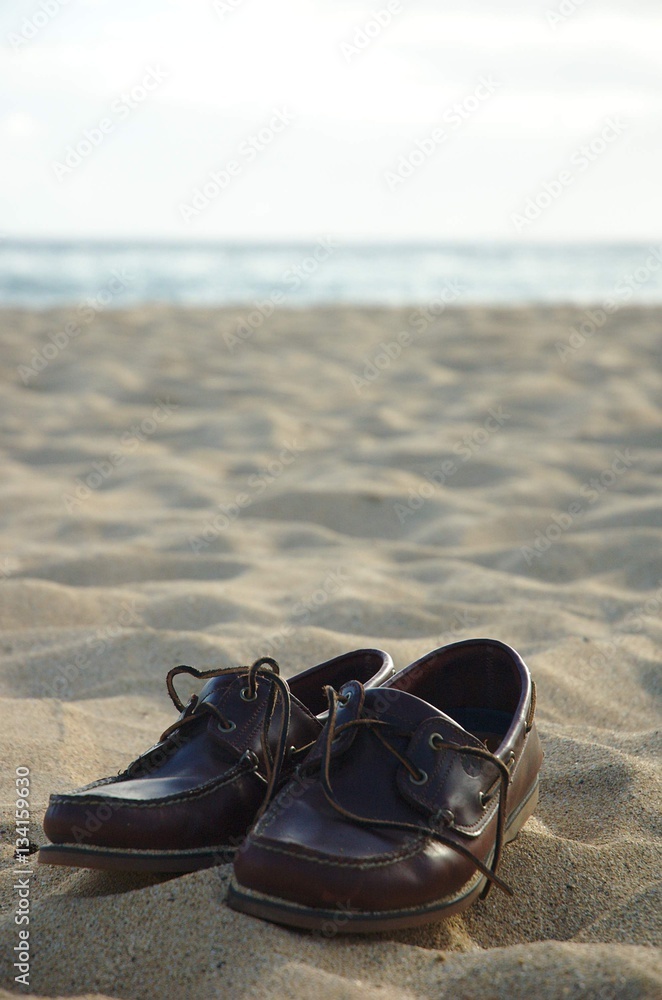 Fototapeta premium Shoes in the sand