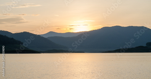 Mountains near water in morning day and fresh air with sunset