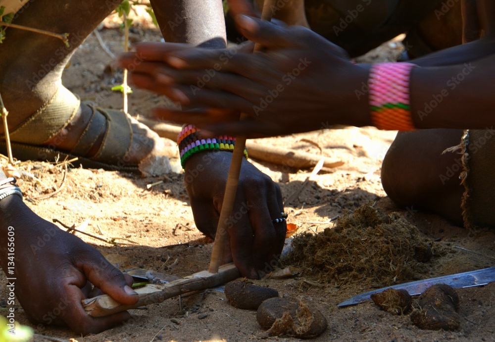 Hadzabe men lighting a fire by hand drill Hadzabe men lighting a fire by hand drill