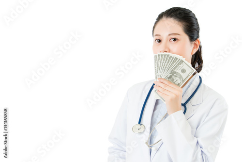 Valokuva asian woman doctor chuckle snicker take money bribery